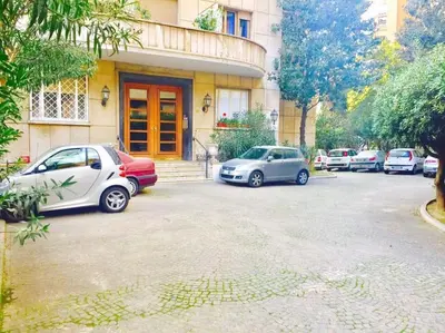 a group of cars parked in front of a building at Lovely apartment near Rome Vatican in Rome