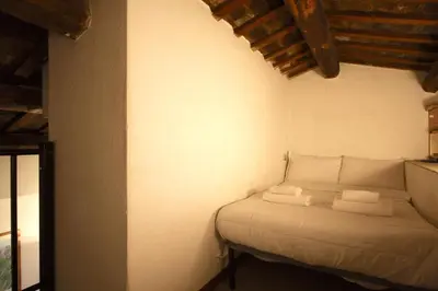 a bedroom with a bed with towels on it at Top floor studio in Campo de Fiori in Rome