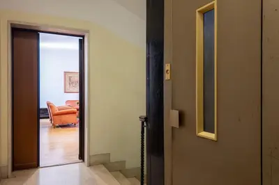 an open door to a living room with an orange couch at Charme e Lusso a San Pietro in Rome