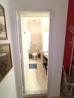 a bathroom with a toilet and a sink at san giovanni - re di roma apartment in Rome