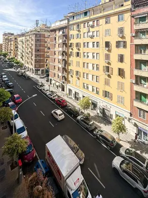 a city street with cars and a truck and buildings at Lilla Boutique Apartment in Rome