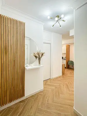 a living room with a ceiling fan and wooden floors at Lilla Boutique Apartment in Rome