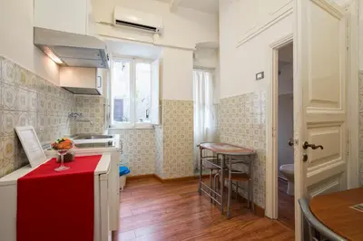 a kitchen with a red counter top in a room at Navona Tower Apartments in Rome