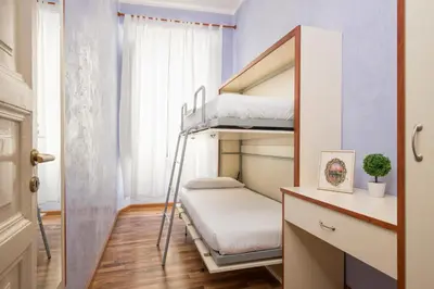 a small room with bunk beds and a window at Navona Tower Apartments in Rome