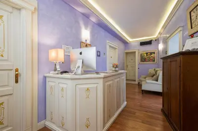 a room with purple walls and a desk with a computer on it at Navona Tower Apartments in Rome