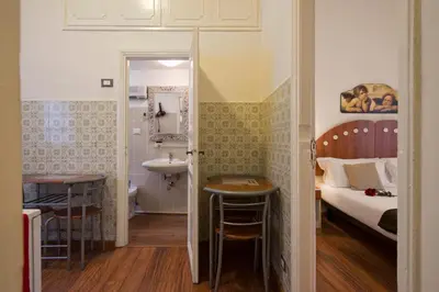 a bedroom with a bed and a bathroom with a sink at Navona Tower Apartments in Rome