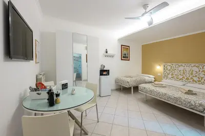 a living room with a couch and a table at Triple room a few steps from Tiber in Rome
