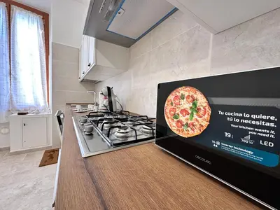 a pizza on a tv screen in a kitchen at Giuli-Etta a Testaccio in Rome