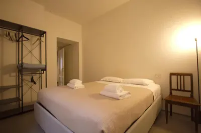 a bedroom with a bed with towels on it at Cartari Holiday House in Campo de Fiori in Rome