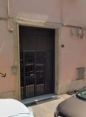 a door with a gate in the side of a building at Dimora Appia in Rome