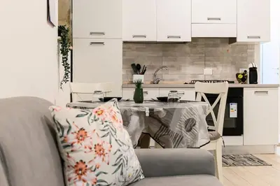 a kitchen with a table with a couch and a table and a kitchen at La Scaletta Furio Camillo in Rome
