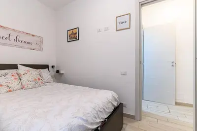a bedroom with a bed and a sliding glass door at La Scaletta Furio Camillo in Rome
