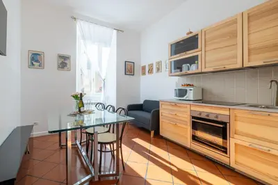 a kitchen with a table and a dining room at Colosseo 85 in Rome