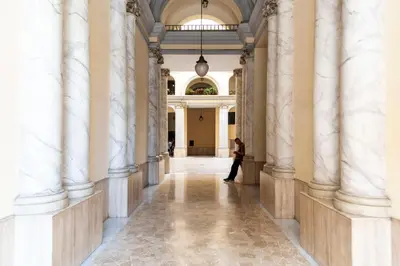 a person walking through a hallway in a building at Merulana Suite Apartment in Rome