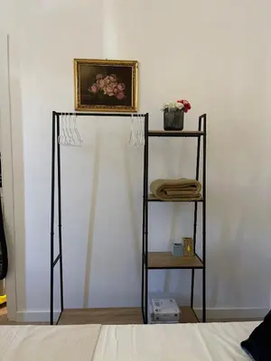 a shelf with a picture on top of a wall at Casa Sara in Rome