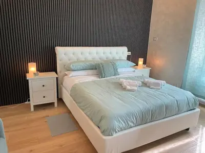 a white bed with two pillows on it in a bedroom at Mary St Peter Vatican Loft in Rome