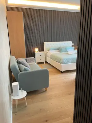 a bedroom with a bed and a couch and a chair at Mary St Peter Vatican Loft in Rome