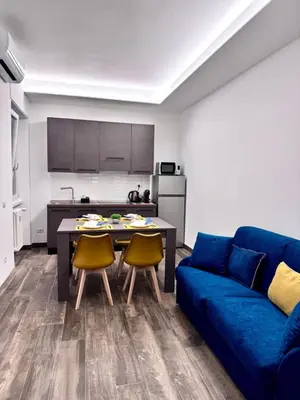 a living room with a blue couch and a table at Eve&Gio Apartment Appio 2 room 2 bath in Rome