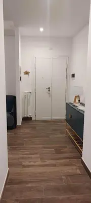 an empty room with a kitchen and a blue cabinet at Eve&Gio Apartment Appio 2 room 2 bath in Rome