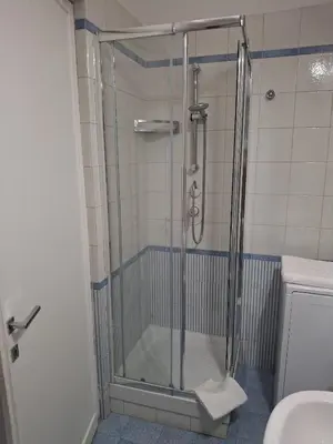 a shower with a glass door in a bathroom at Fleming hill apartments - Free Private Parking & Garden in Rome