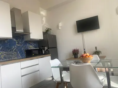 a kitchen with a glass table and white cabinets at Peace Window Roma in Rome
