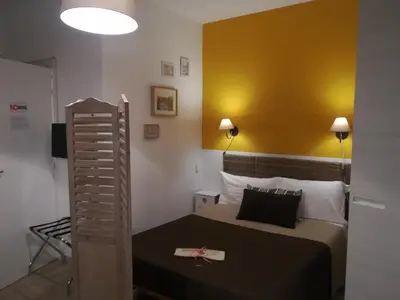 a bedroom with a bed and a yellow wall at FantAflat in Rome