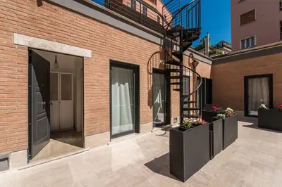 a balcony of a brick building with a spiral staircase at FantAflat in Rome