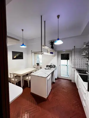 a kitchen with a table and a dining room at Casa di Gianni in Rome