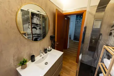 a bathroom with a sink and a mirror at Liu Home Tiburtina Stay in Rome in Rome