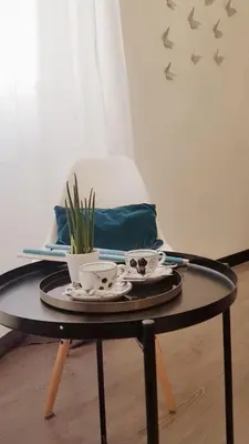 a coffee table with two cups and a plant on it at Nobilcasa Suites in Rome