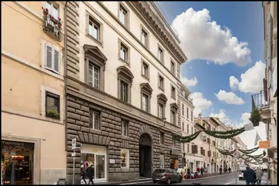 a building on the side of a city street at Exclusive Apartment in the Heart of Rome in Rome
