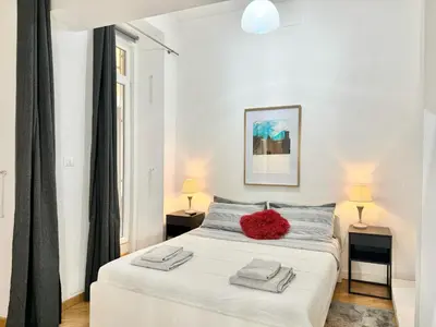 a bedroom with a white bed with a red pillow on it at Exclusive Apartment in the Heart of Rome in Rome