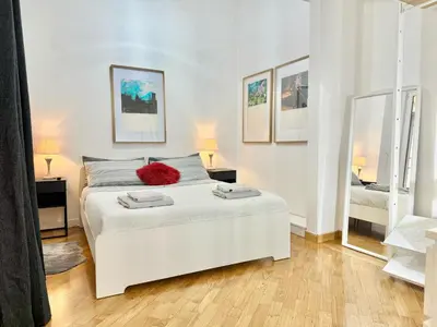 a bedroom with a white bed and two mirrors at Exclusive Apartment in the Heart of Rome in Rome