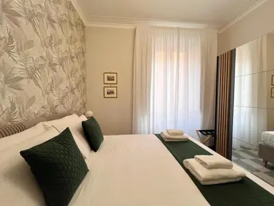 a bedroom with a large white bed with towels on it at Domus Dolce Vita - Apartment in Rome