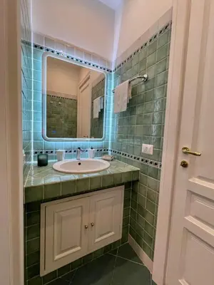 a bathroom with a sink and a mirror at Domus Dolce Vita - Apartment in Rome