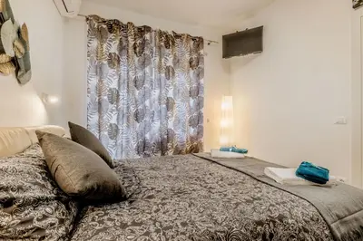 a bedroom with a large bed with a curtain at White Living R-home in Rome