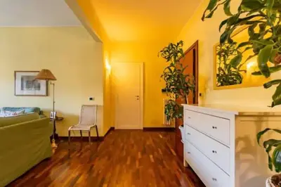 a living room with yellow walls and a white dresser at Notte al Vaticano in Rome