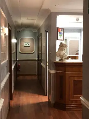 a hallway in a building with a lion statue at Sandel Giubileo Hotel in Rome