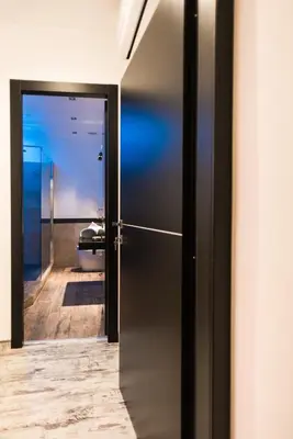 a hallway with a door leading to a bathroom at Trevi & Pantheon Luxury Rooms in Rome