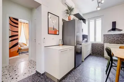 a kitchen with a refrigerator and a table at BDC - Termini Dreaming 3-BDR in Rome