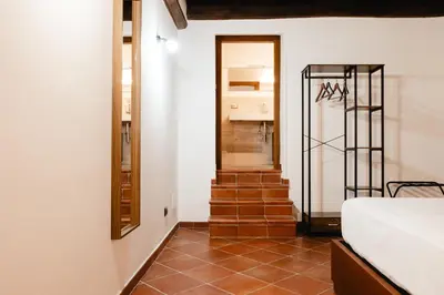 a room with a staircase leading to a bedroom at Domus LXVII Monti in Rome