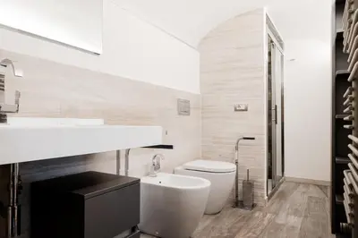 a bathroom with a white toilet and a sink at Domus LXVII Monti in Rome