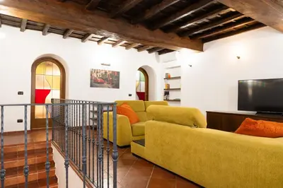 a living room with a couch and a tv at Domus LXVII Monti in Rome