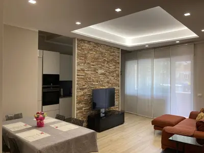 a living room with a table and a tv at Cami Luxury Flat Rome in Rome