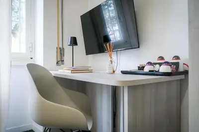 a table with a chair in a room at Marconi Suites in Rome
