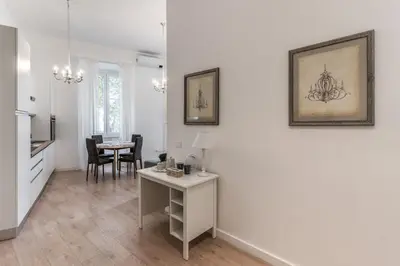 a living room with white walls and a table at Fresh House Vaticano in Rome