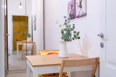 a table with a vase with a plant on it at Stanza Comoda e Silenziosa con Bagno Privato e Area Lavoro e Relax in Rome