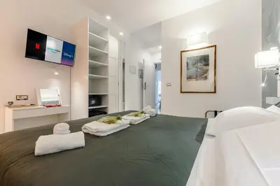 a bedroom with a bed with towels on it at Perfect! Vatican Location in Rome