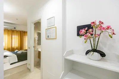 a vase of flowers on a counter in a room at Perfect! Vatican Location in Rome