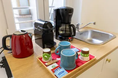 a kitchen counter with a coffee maker and cups on a tray at Perfect! Vatican Location in Rome